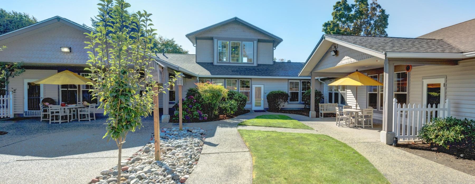 a row of living areas with lush landscaping