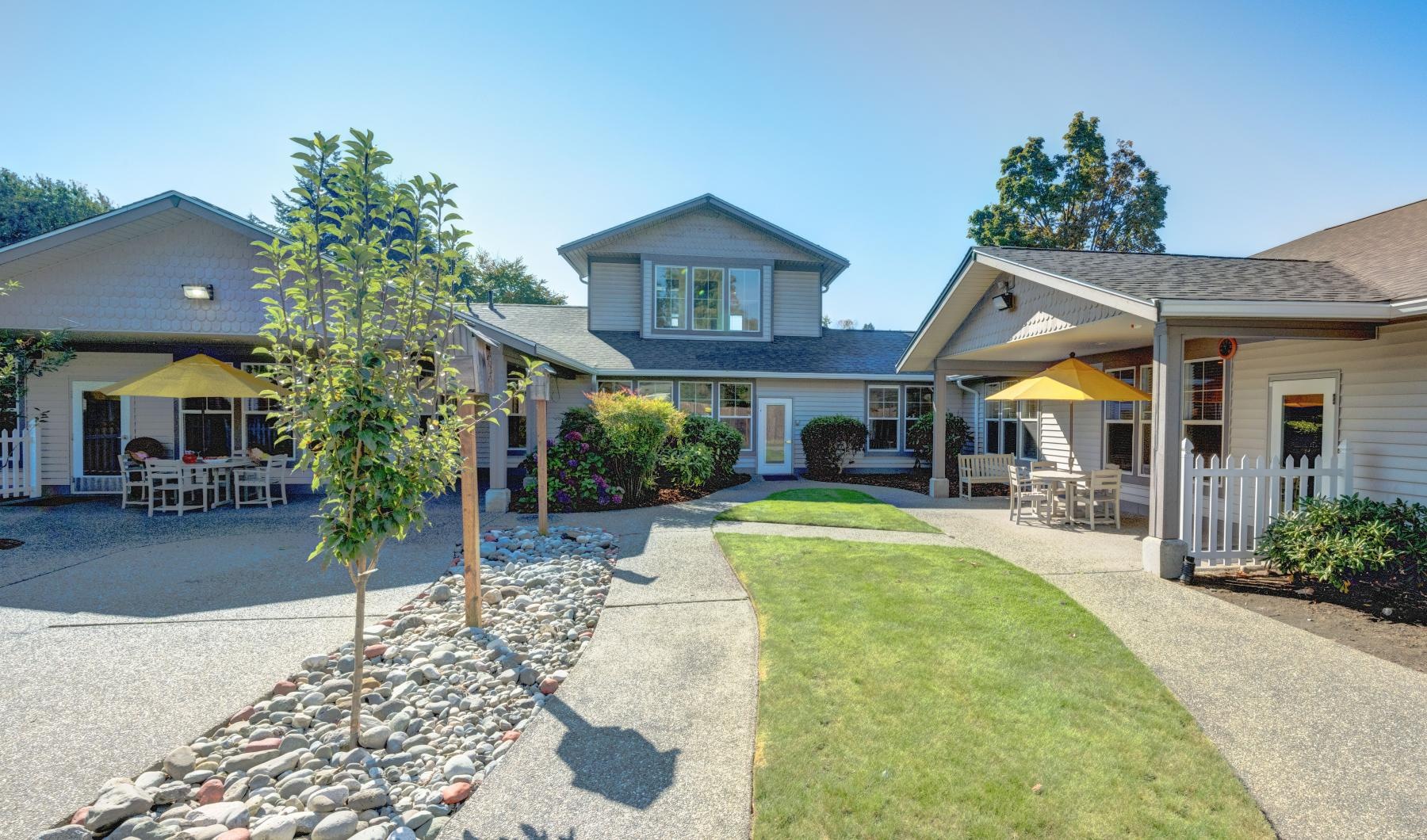 a row of living areas with lush landscaping